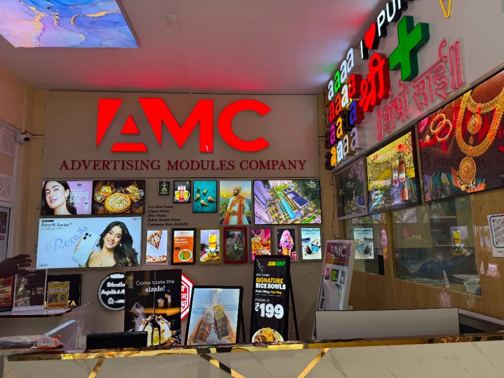 The Advertising Modules Company showroom in Gultekadi, Pune, displaying backlit fabric light boxes and clip-on frames